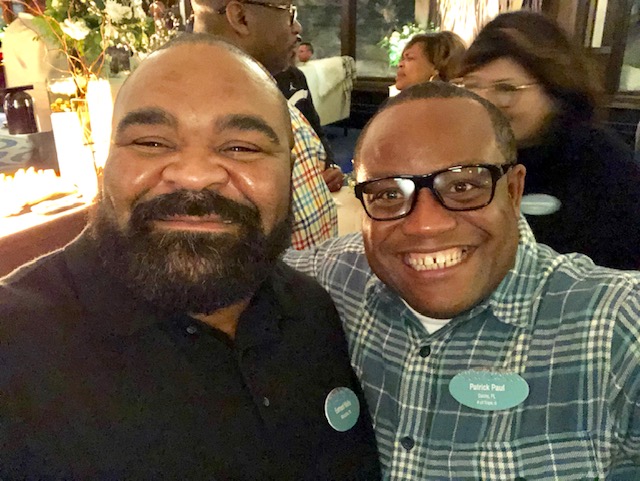 Two men smiling for a picture at an event.