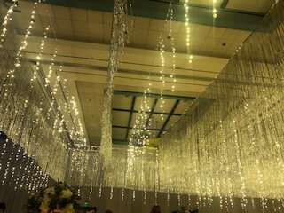 A room with many lights hanging from the ceiling.