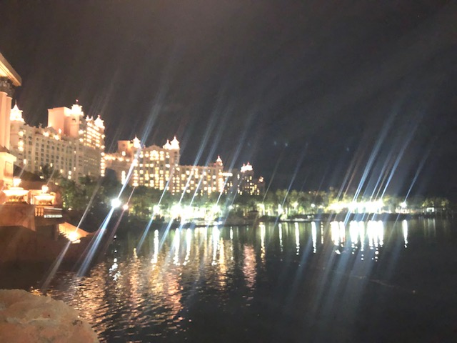 A night view of the water and buildings.