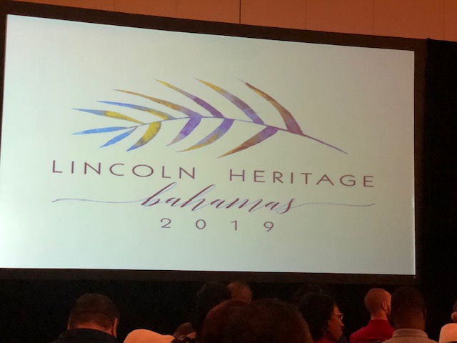 A large screen showing the lincoln heritage bahamas logo.